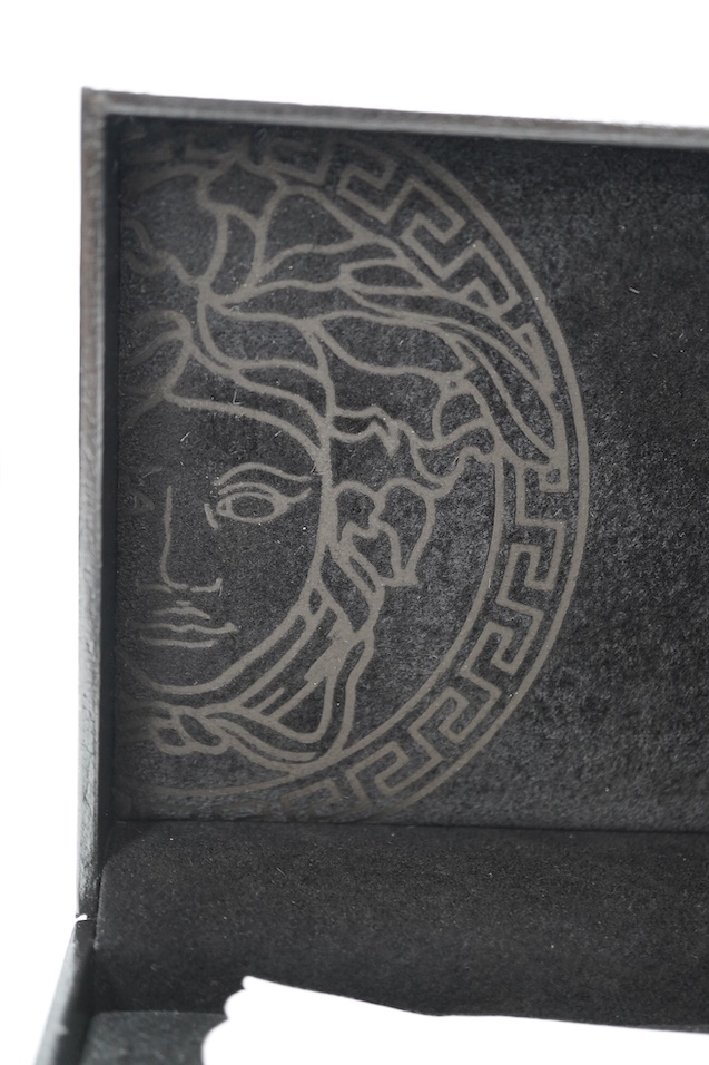 Two boxed pens; a Versace and a Cross, both with outer cardboard boxes. Condition - Versace pen good, display box good, outer box damaged. Cross pen good, ink bottle good, case damaged